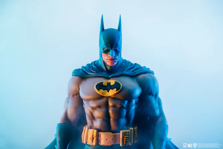 Front-facing close-up of Batman’s head and chest in classic suit on a white background