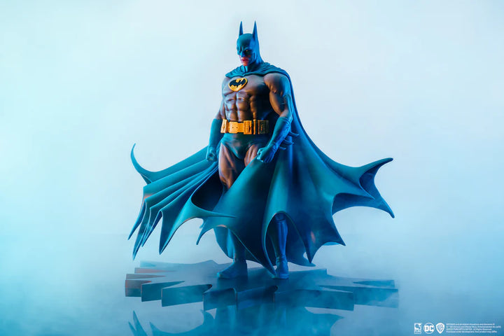 Angled view of Batman statue with dramatic lighting and wide cape display on a white background