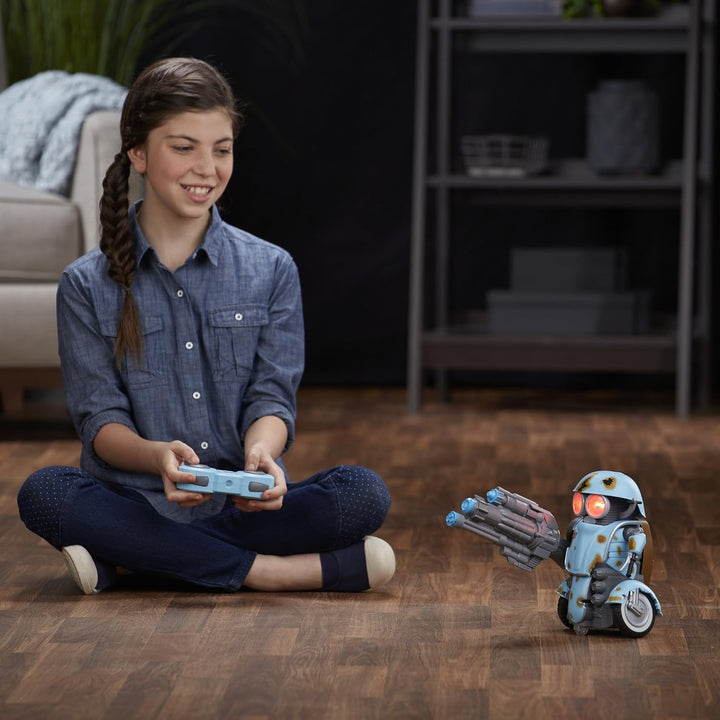 Girl playing with a toy robot on a wooden floor