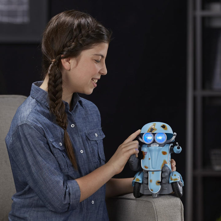 Young girl interacting with a robot toy on a couch